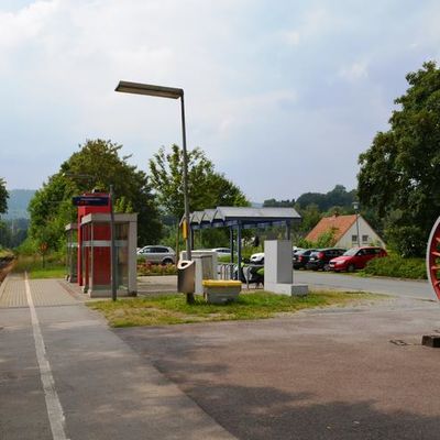 Der Haltepunkt der Bahn in Sandebeck besteht aus einem Bahnsteig mit Wartehäuschen und Fahrradunterstand aus Glas. Ein rotes Rad einer alten Dampflokomotive ist dort als Verzierung aufgestellt.